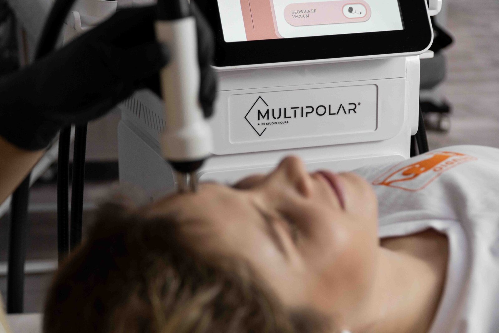 Wellness client receiving a radiofrequency facial treatment with MULTIPOLAR PRO technology.