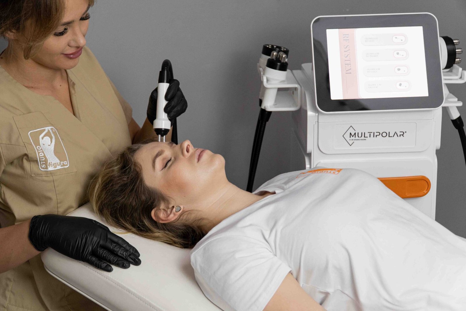 Woman enjoying a relaxing MULTIPOLAR PRO facial session in a modern wellness and aesthetics clinic.